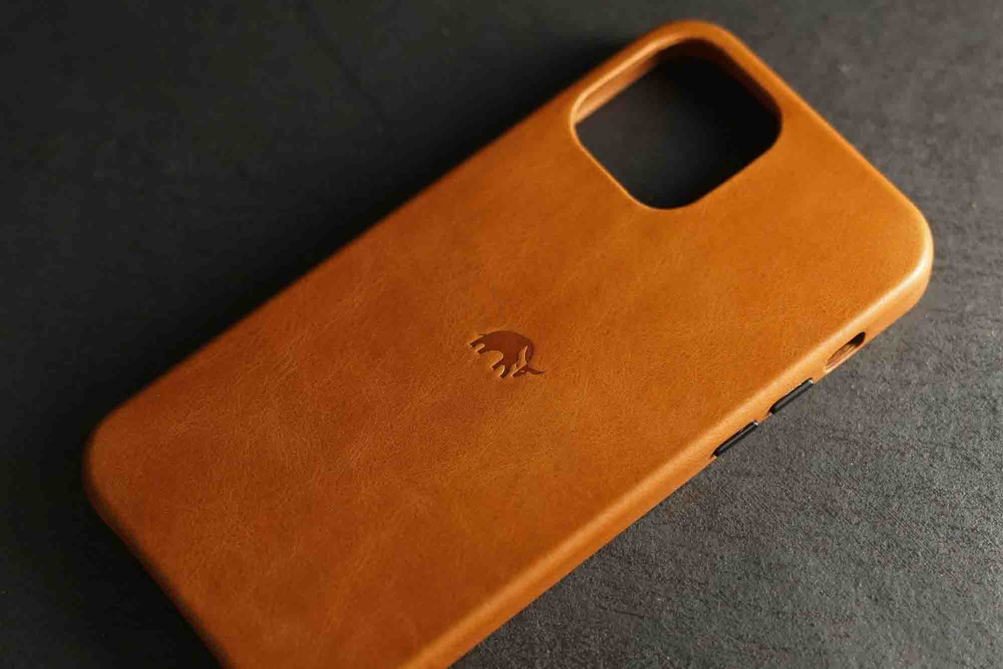 An empty tan leather iPhone 12 case from Bullstrap