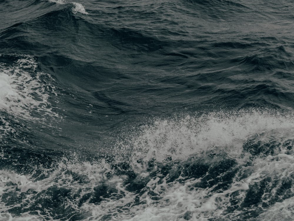 Ocean waves with white foam and dark water texture