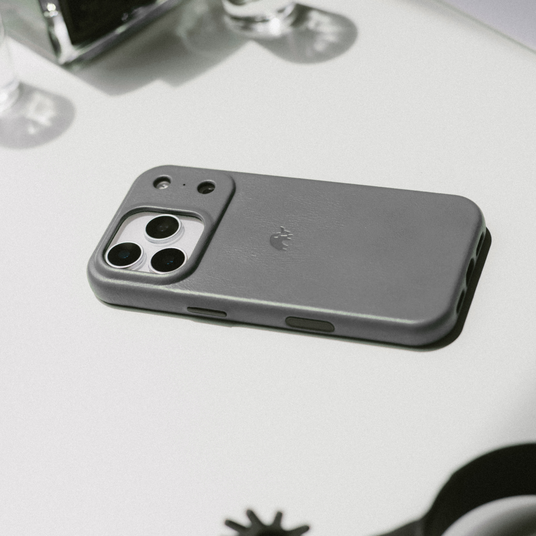 slate grey iPhone 17 case laying flat on a white desk
