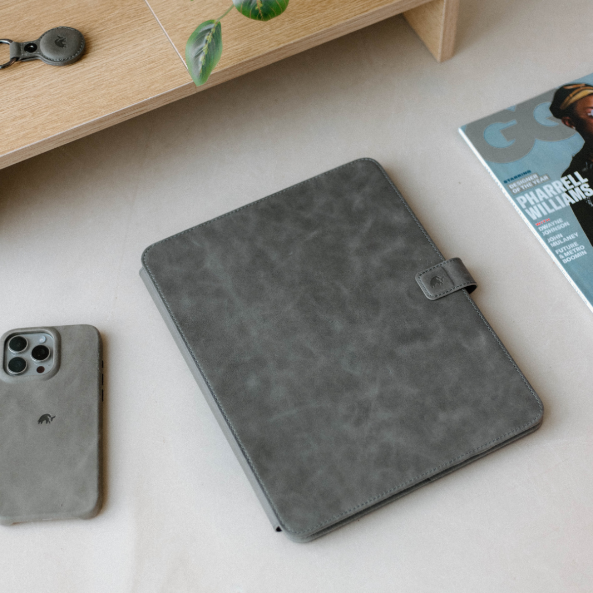 Leather iPad Case in gray color on a table with a phone and magazine