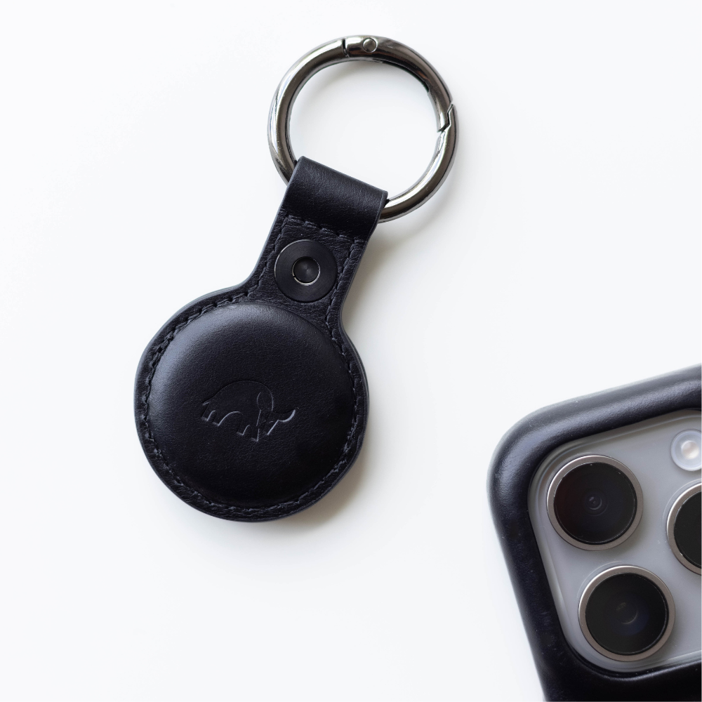Black leather keychain holder for AirTag with a circular design