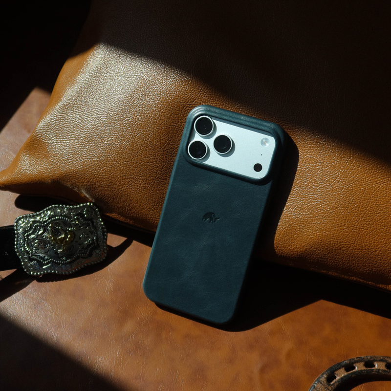 Back view of Contemporary Plateau Case in Ocean showing raised camera plateau and full-grain leather on brown cushion