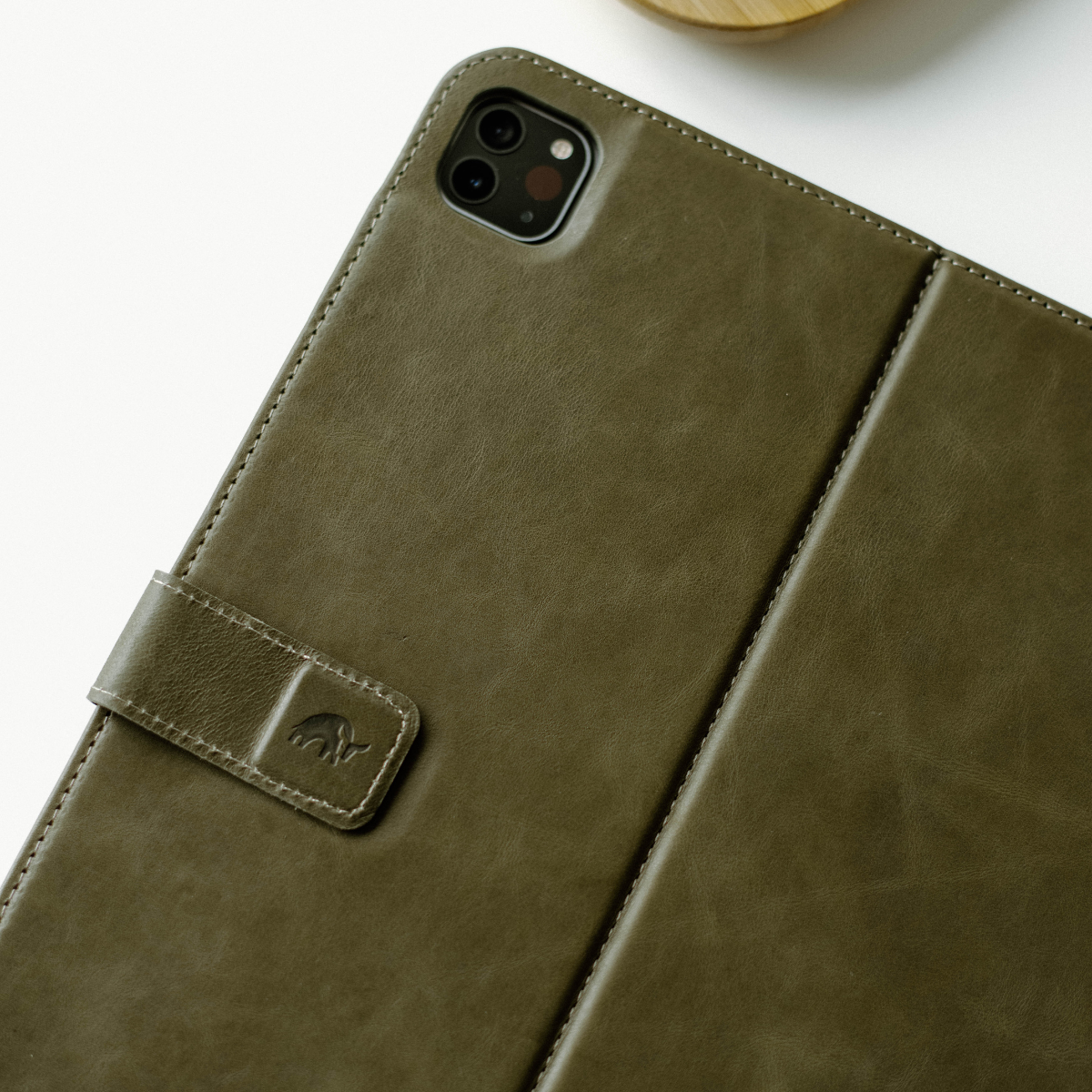 Olive green leather iPad case with a clasp and embossed logo