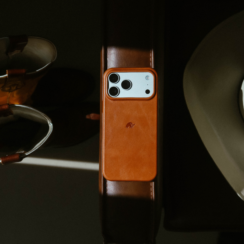 Top-down view of Contemporary Plateau MagSafe leather case in sienna showing wallet attachment and camera cutout