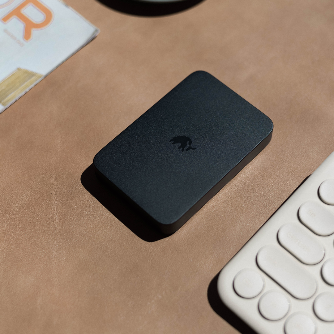 Bullstrap MagSafe Power Bank on a surface with a keyboard and magazine