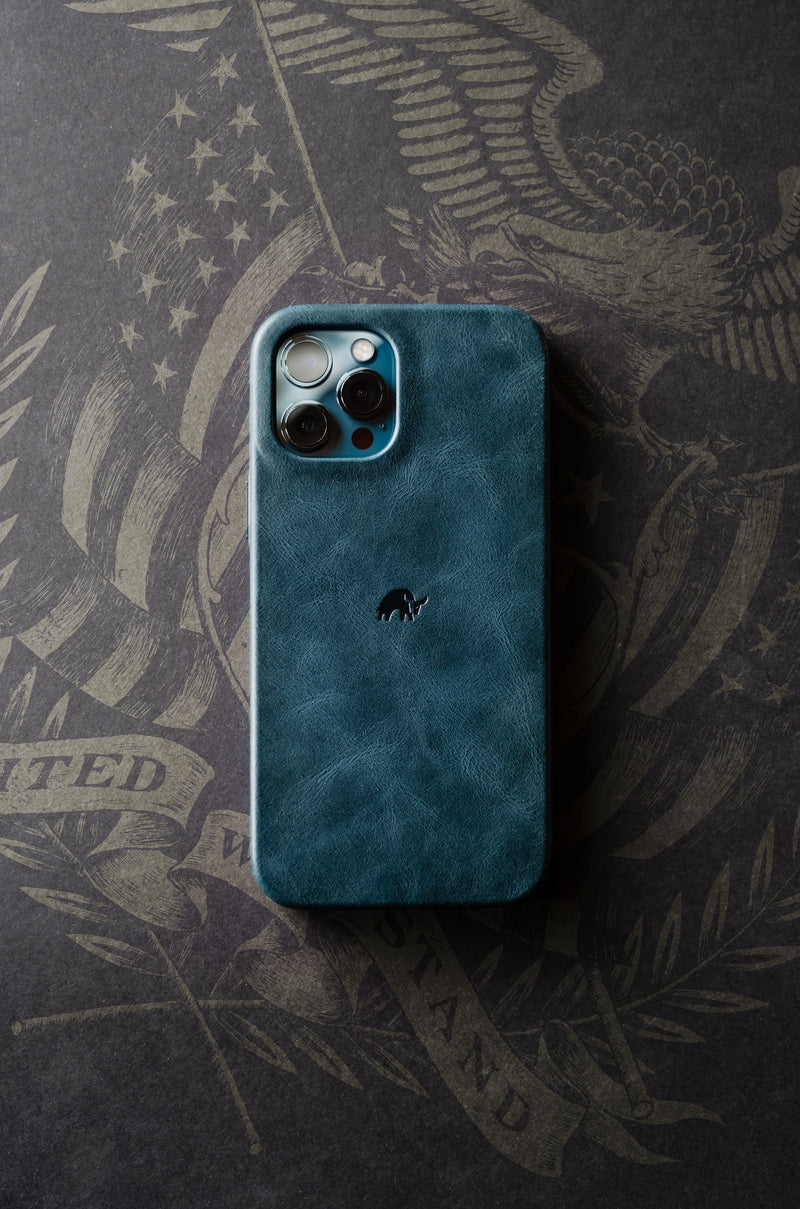 Ocean leather phone case with logo on a dark background