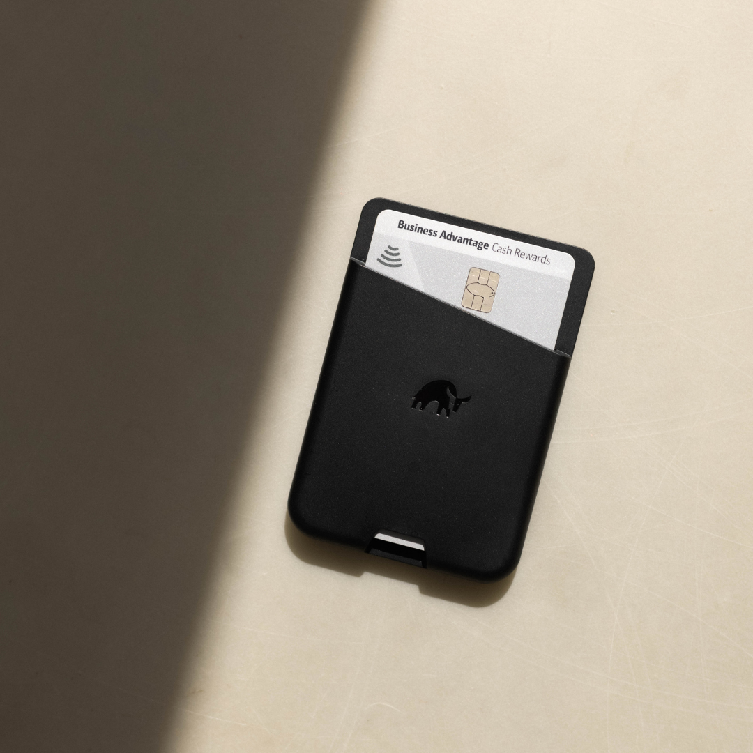 Black wallet with a Business Advantage card partially visible on a light surface.