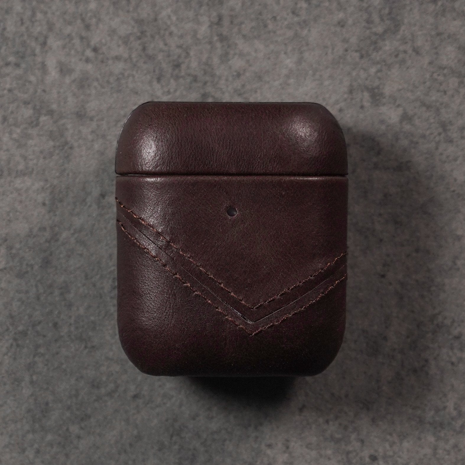 Brown leather AirPods case with chevron stitching
