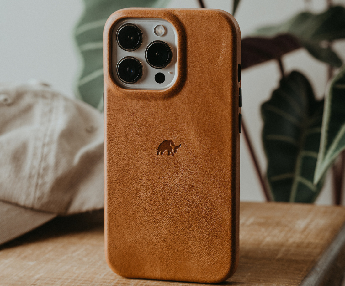 A brown leather phone case with a bull logo