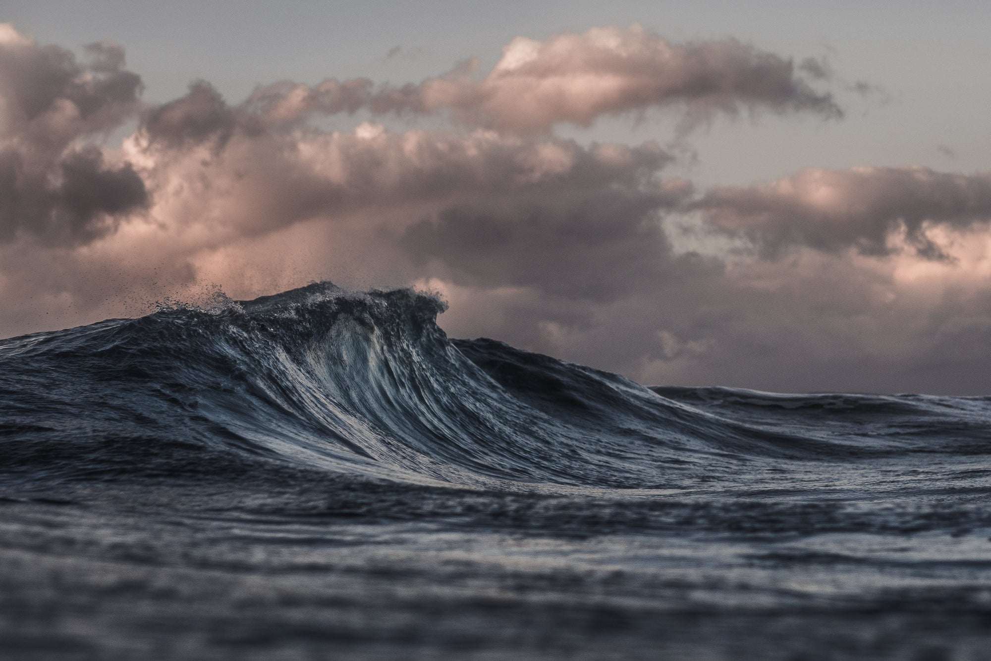 A close-up view of ocean waves under a cloudy sky