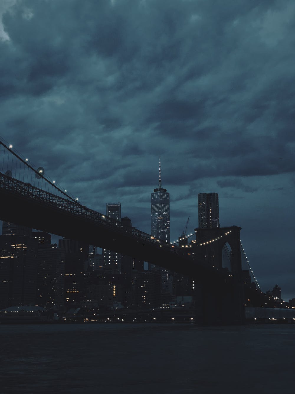Brooklyn Bridge with city skyline at dusk