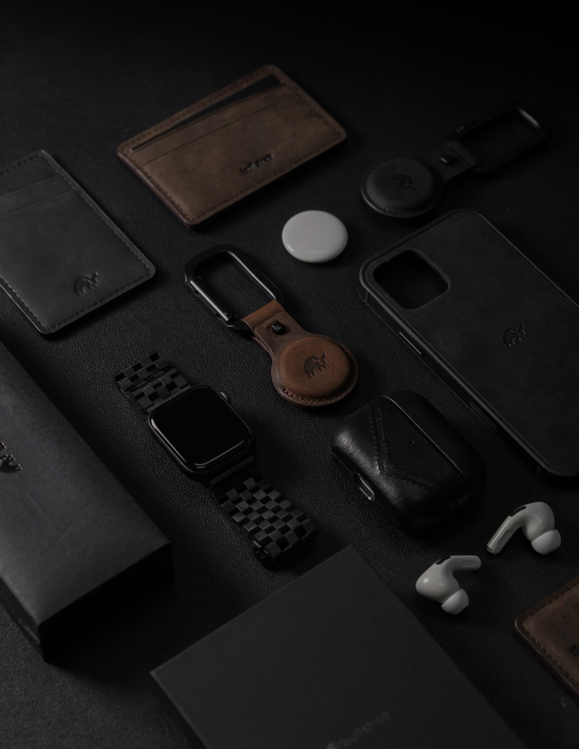 A collection of Bullstrap products including wallets, phone cases, and accessories on a dark background.