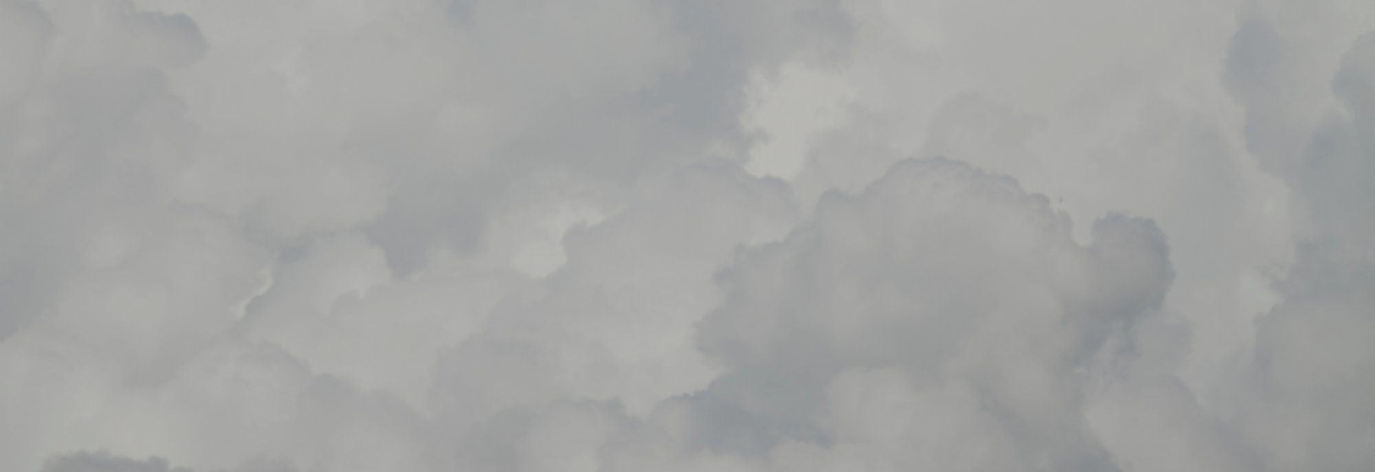 Layered soft gray cumulus clouds filling the frame under diffused daylight.