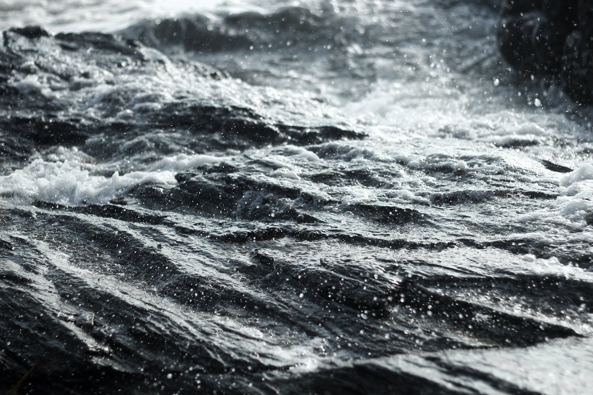 Water splashing on rocky surface