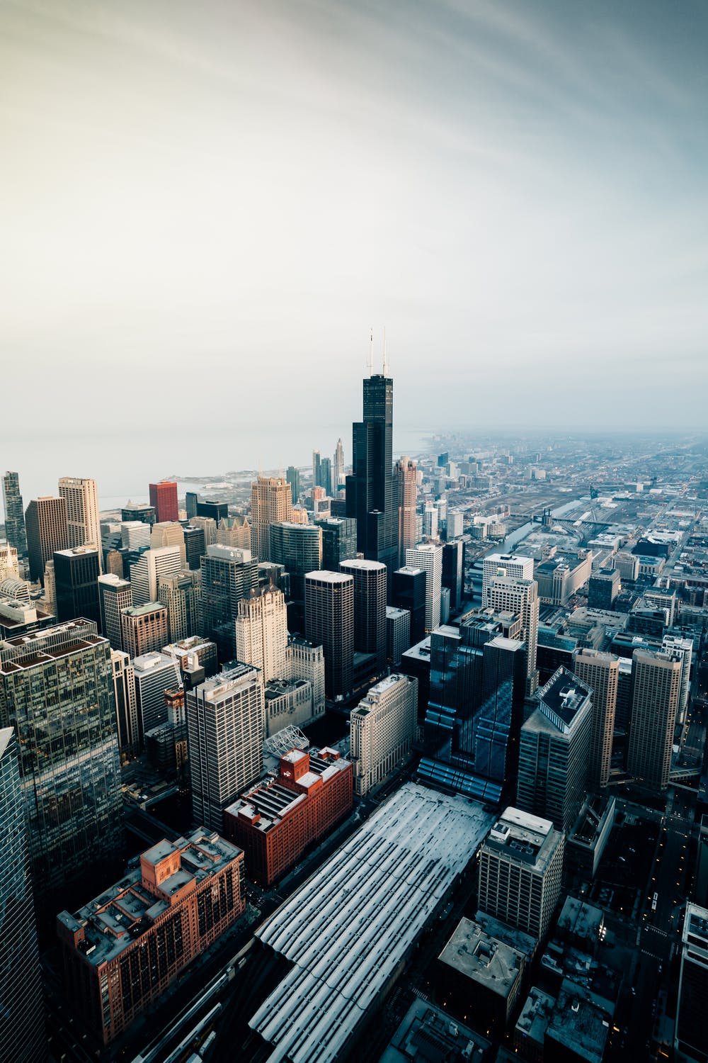 Aerial view of a city skyline with tall buildings and a cloudy sky