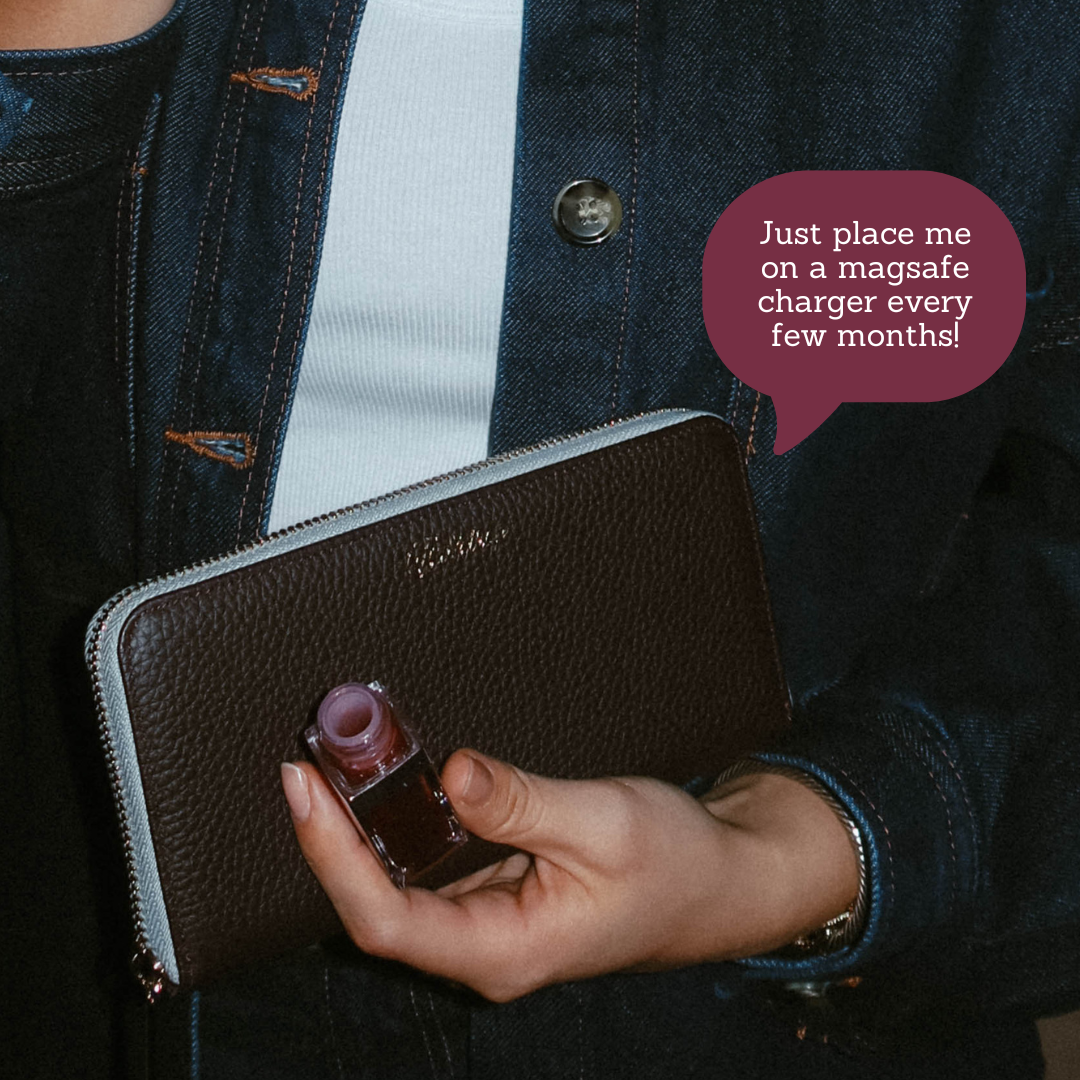 Brown zip-around wallet held in hand with speech bubble: 'Just place me on a magsafe charger every few months!'
