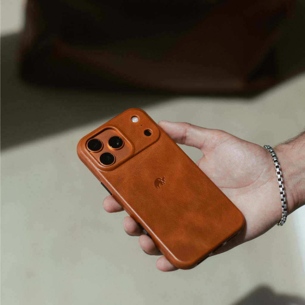 Sienna leather minimalist phone case on an iPhone held in a hand