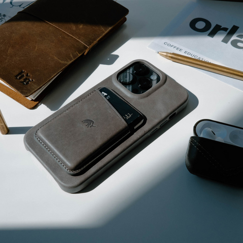 Leather Magnetic Wallet in Slate color on a phone case with accessories