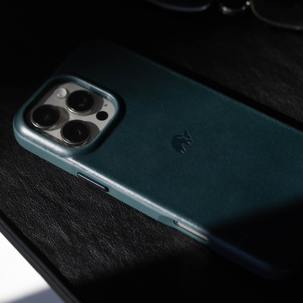 Close-up of a teal iPhone case with a bull logo