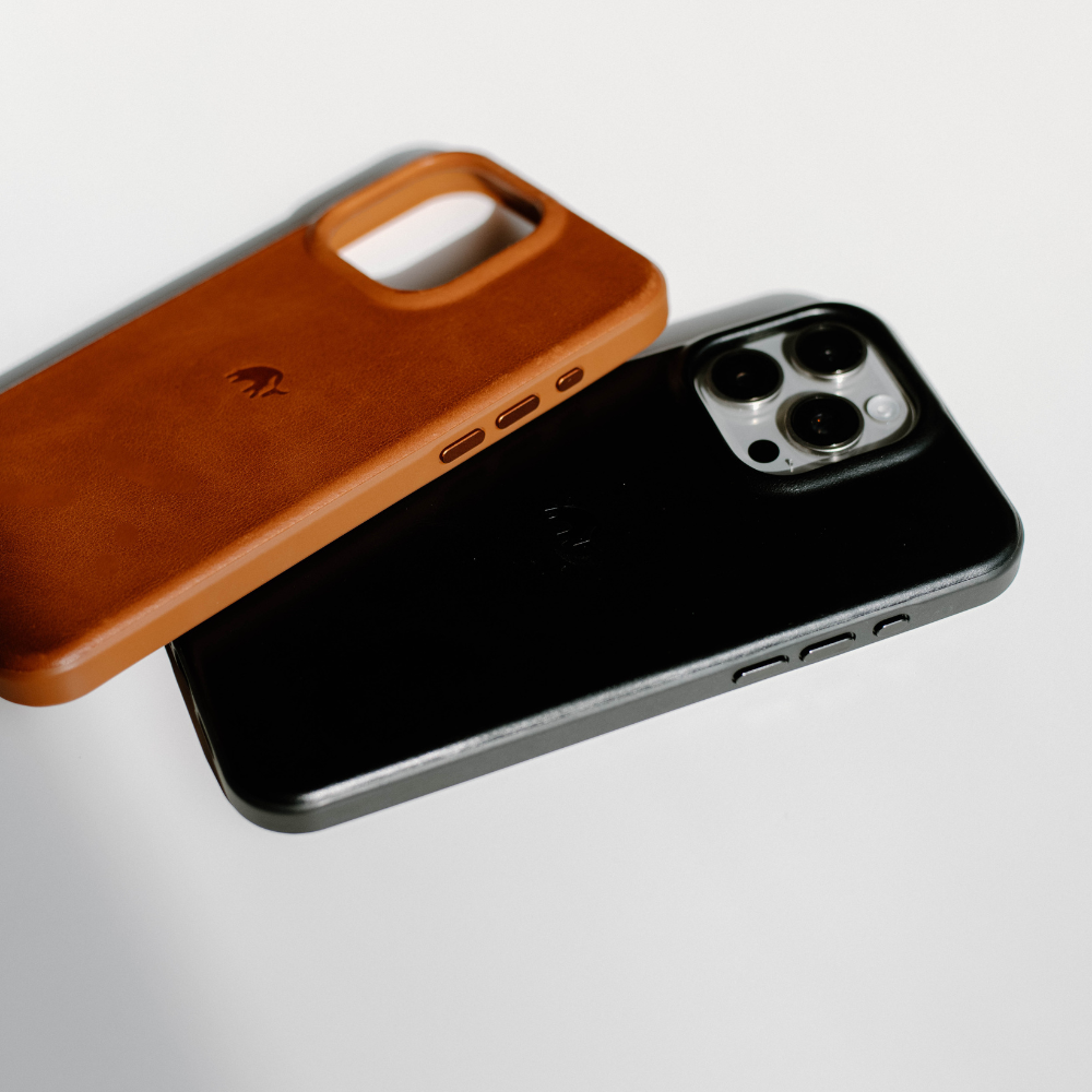 Two phone cases: one black and one brown leather, showcasing their design.