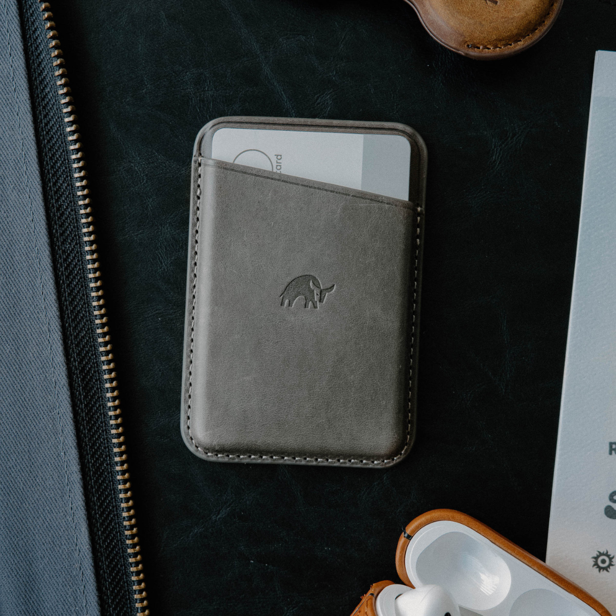 Leather Magnetic Wallet in Slate color, featuring a card slot and embossed logo.