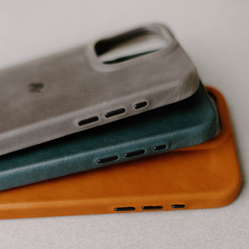Close-up side view of Contemporary Case in ocean showing leather texture and speaker cutouts, stacked over two other colors