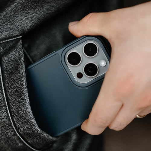 A hand holding a dark blue FRWD phone case with camera cutouts.