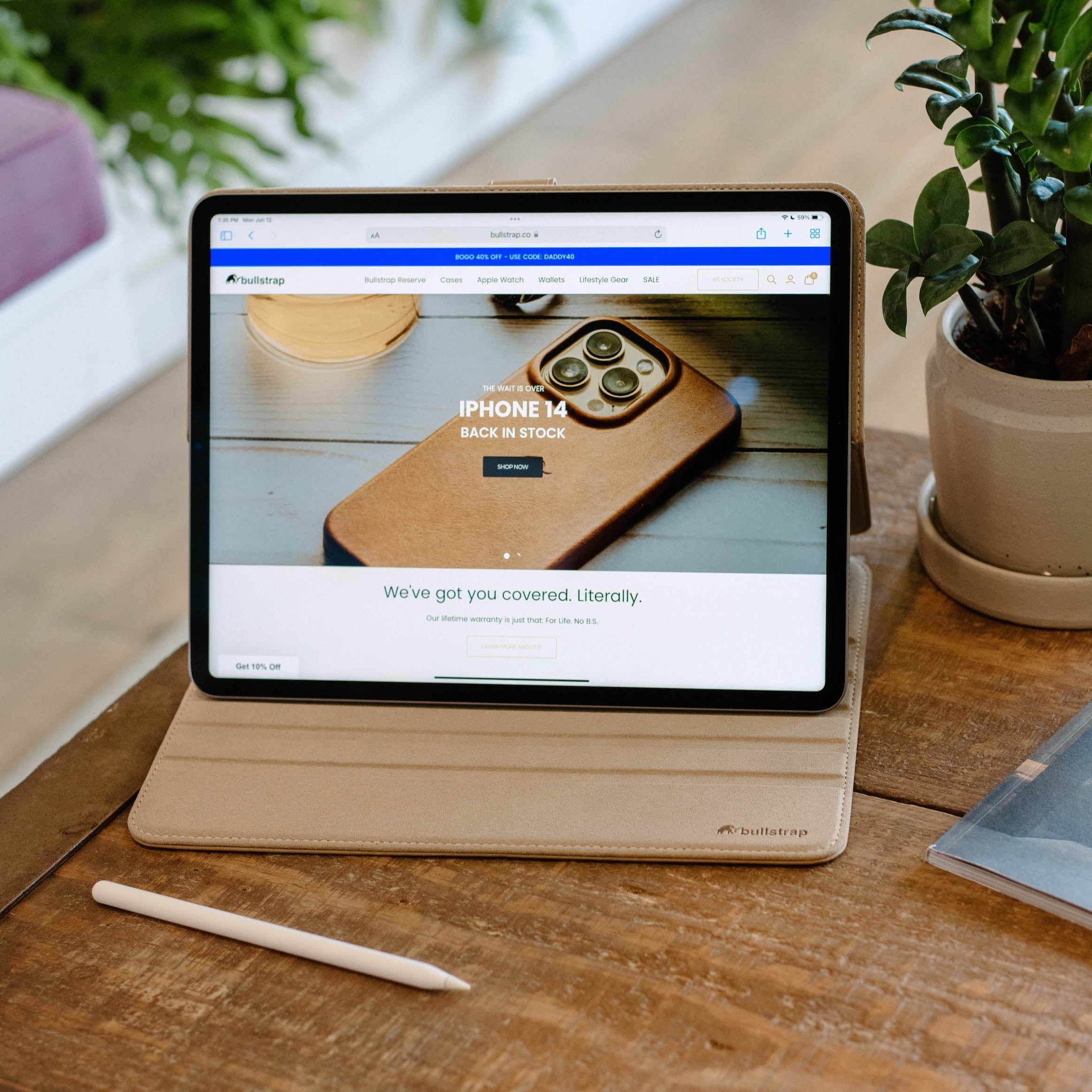 Leather iPad Case - DUNE displayed on a table with an iPad showing the Bullstrap website.