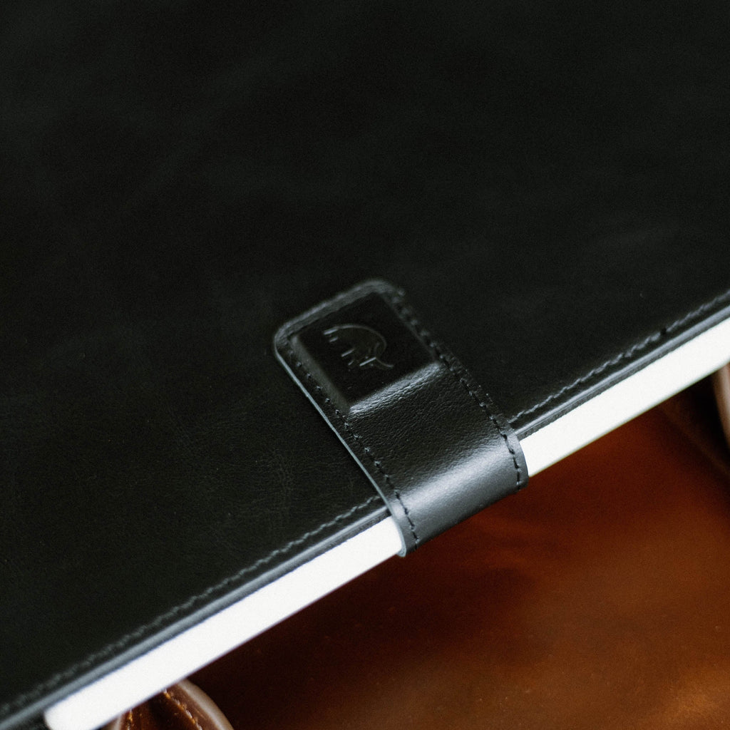 Close-up of the Leather iPad Case in Black Edition, showing the embossed logo and leather texture.