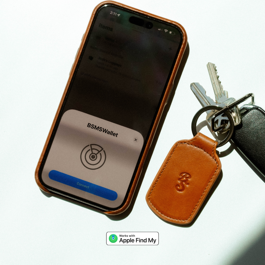 Top-down of Sienna Trace trackable keychain showing leather tag, keys, and Apple Find My badge on white background