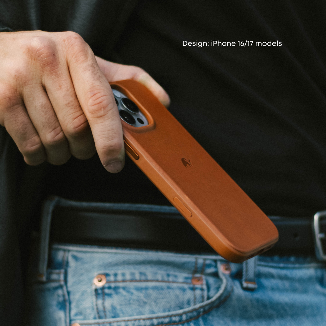 Sienna leather phone case held over jeans pocket, showing camera cutout and embossed brand logo.
