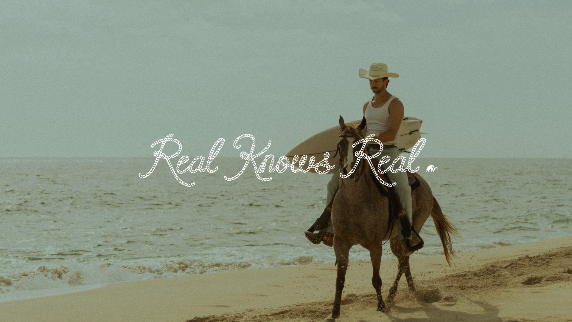 Man in a cowboy hat riding a horse along the beach with a surfboard; overlaid text 'Real Knows Real'.
