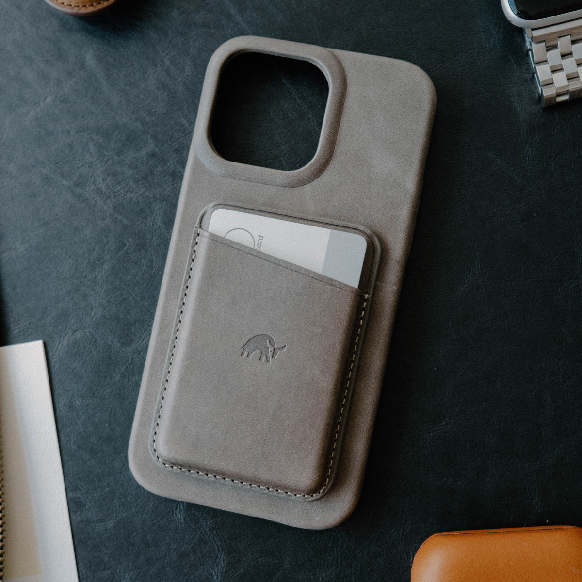 Leather Magnetic Wallet in Slate color with card inserted, placed on a dark surface.