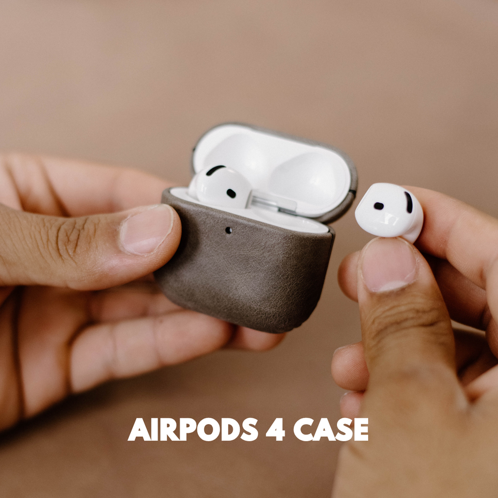 Hands holding slate leather AirPods case with one earbud removed — AIRPODS 4 CASE
