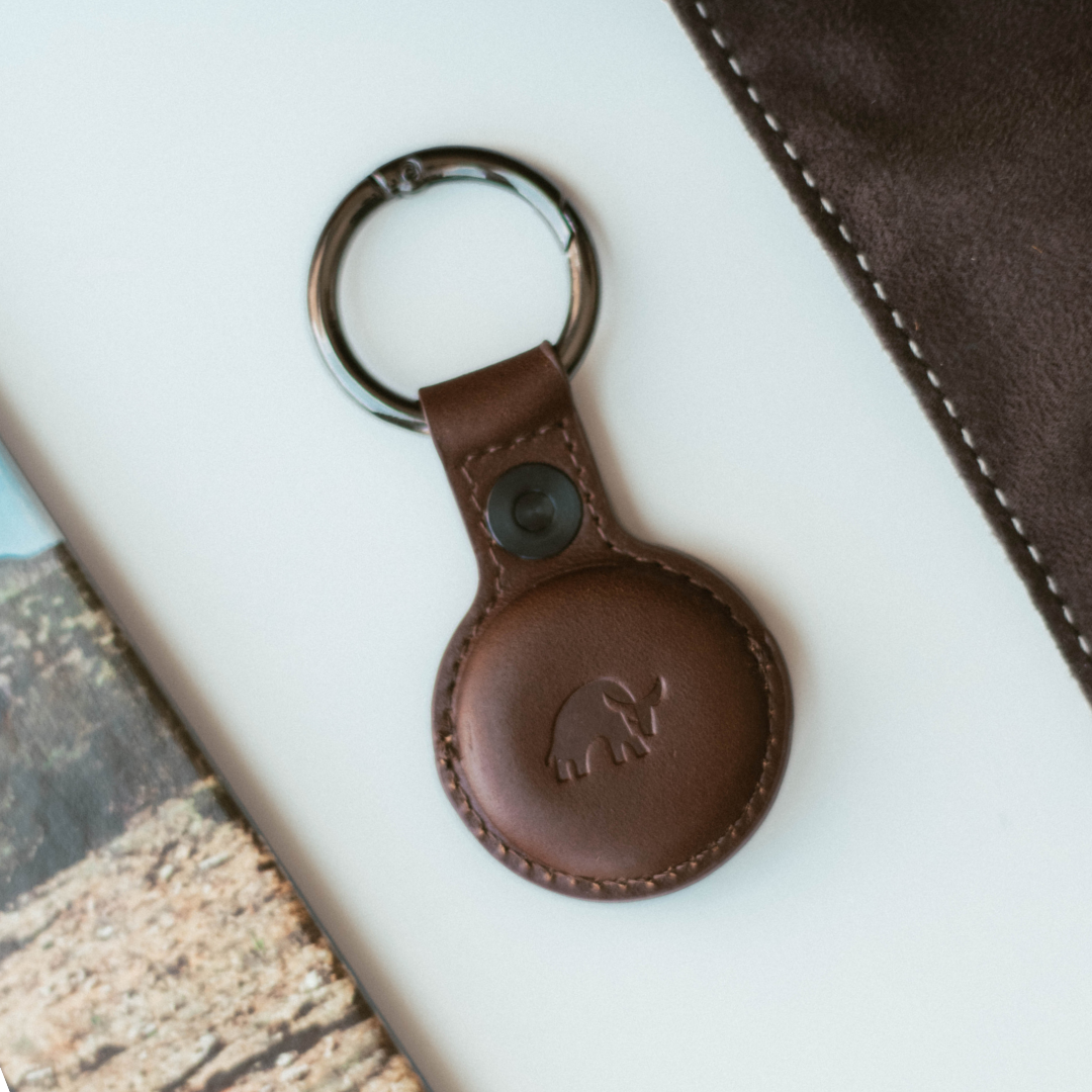 Brown leather keyring AirTag holder with stitched edge and embossed bull logo