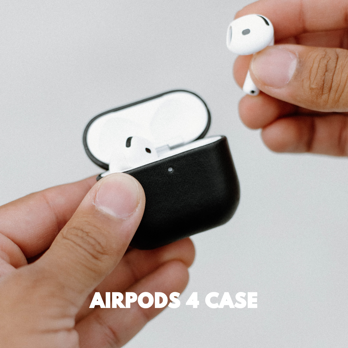 A person holding an AirPods case with AirPods being removed, labeled 'AIRPODS 4 CASE'.
