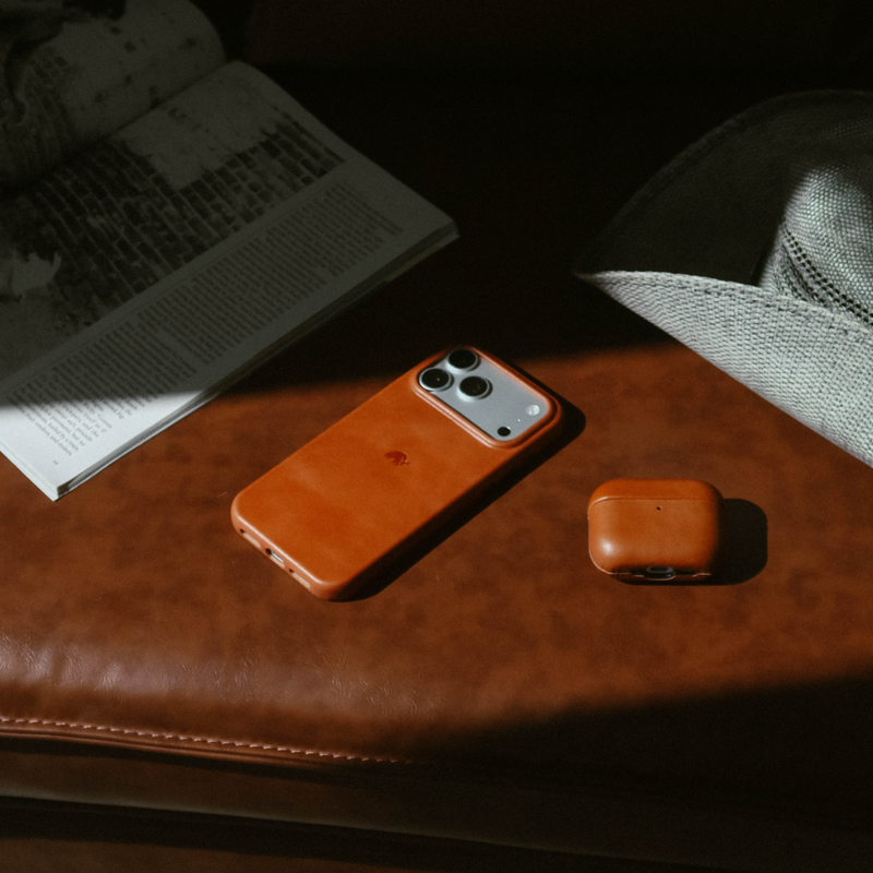 Three-quarter view of The Contemporary Plateau Case in Sienna showing smooth burnished leather and raised camera lip