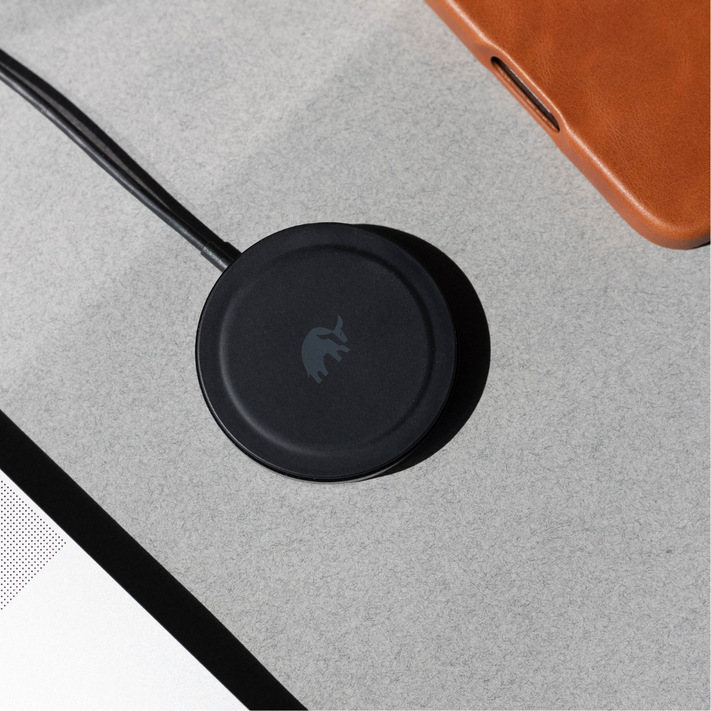 Black wireless charger on a gray surface