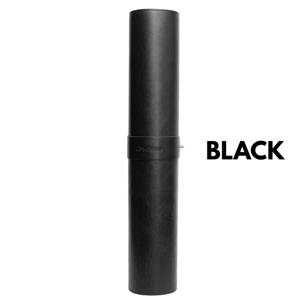 Rolled black leather desk mat secured with a strap; large text 'BLACK' shown to the right