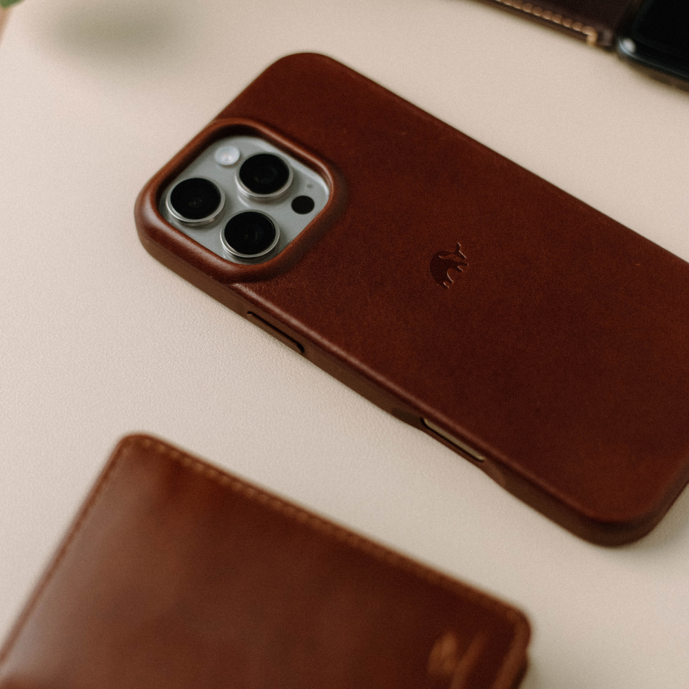 The Flex Case in Terra color, showcasing its design and texture on a surface with a wallet.