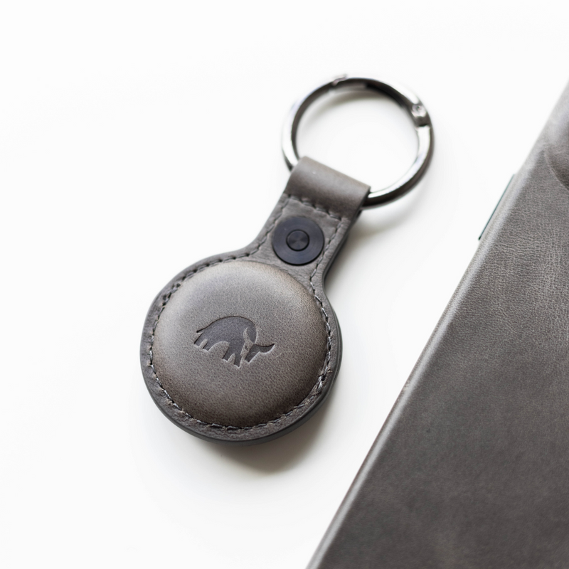Top view of BullTag for AirTag in slate leather with stitched pocket, embossed bull logo, and metal key ring