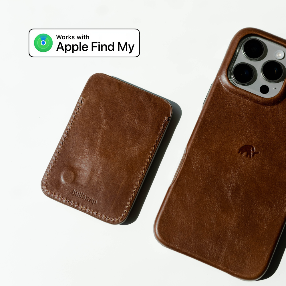 Brown leather iPhone case and matching MagSafe wallet stamped bullstrap, with badge reading 'Works with Apple Find My'