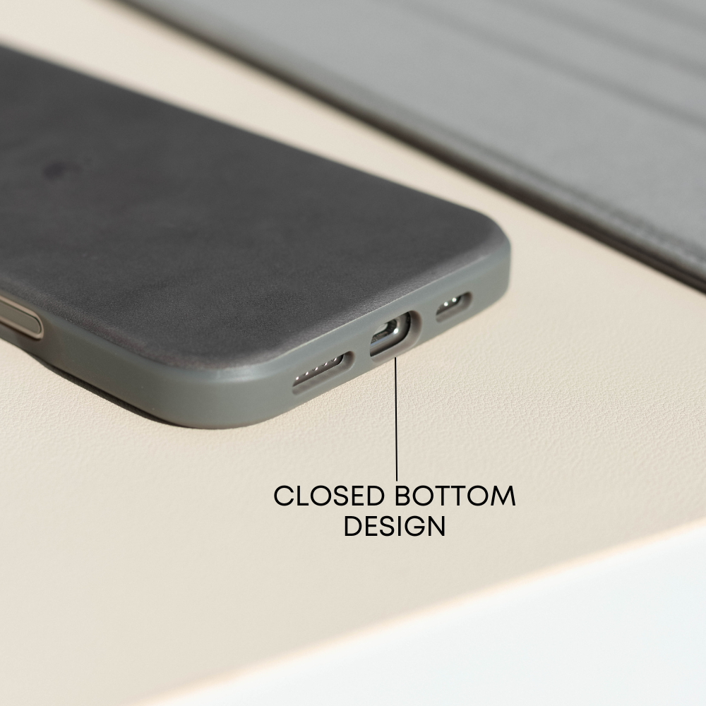 Close-up of phone case bottom showing port openings, suede-like texture, and 'CLOSED BOTTOM DESIGN'.