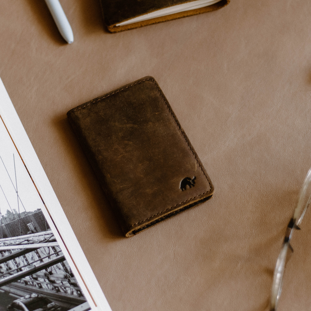 The Messenger Wallet in Terra color, featuring a sleek design and embossed logo.