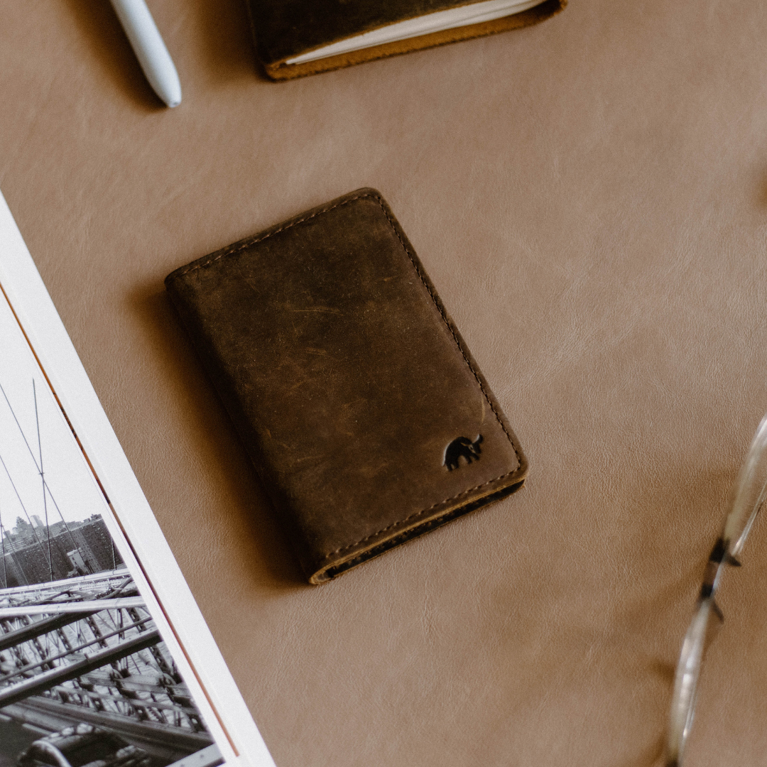 The Messenger Wallet in Terra color, featuring a sleek design and embossed logo.