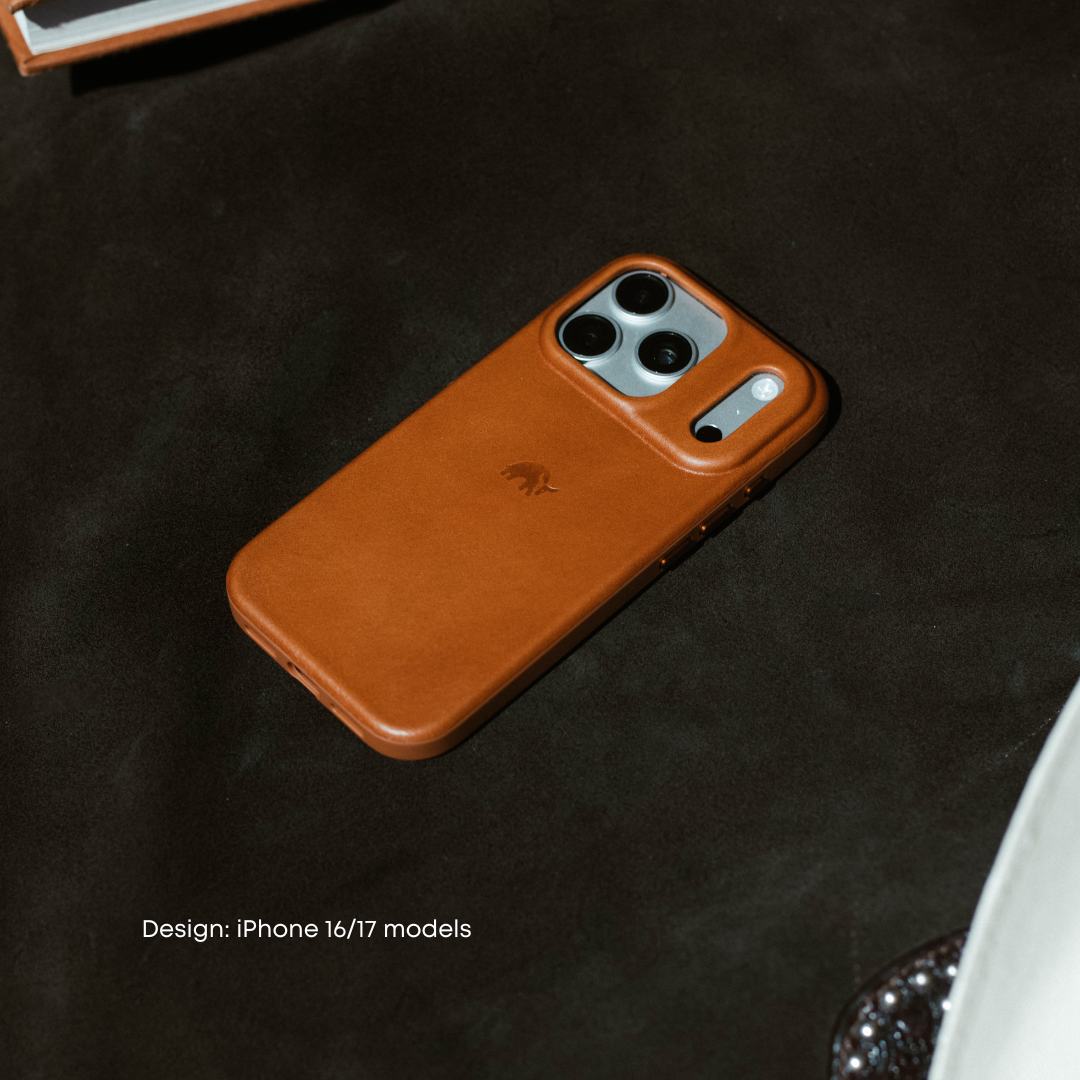 Angled top-down view of Sienna leather Flex Case showing raised camera cutout and embossed logo on a dark suede surface.