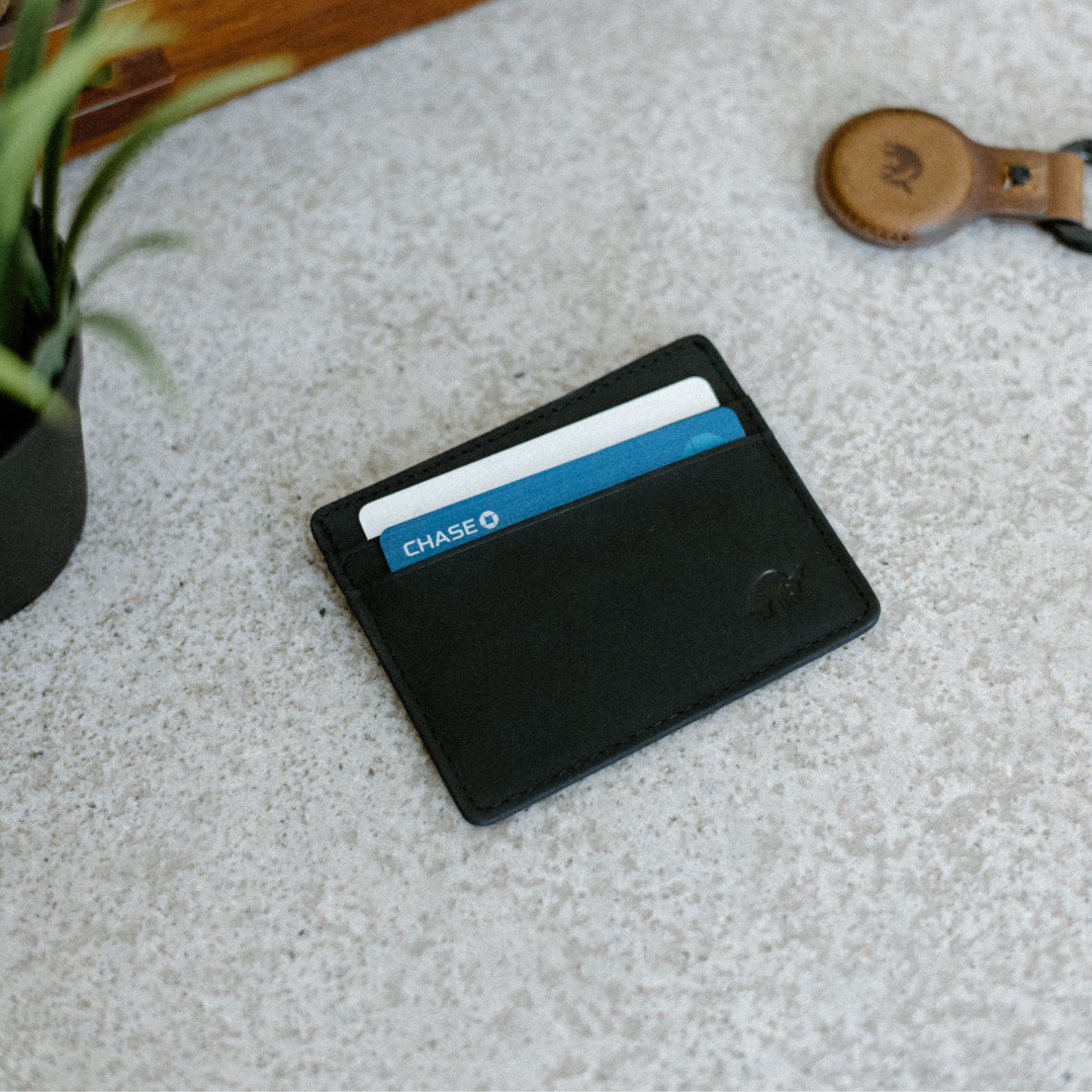 Black leather card holder with two cards visible