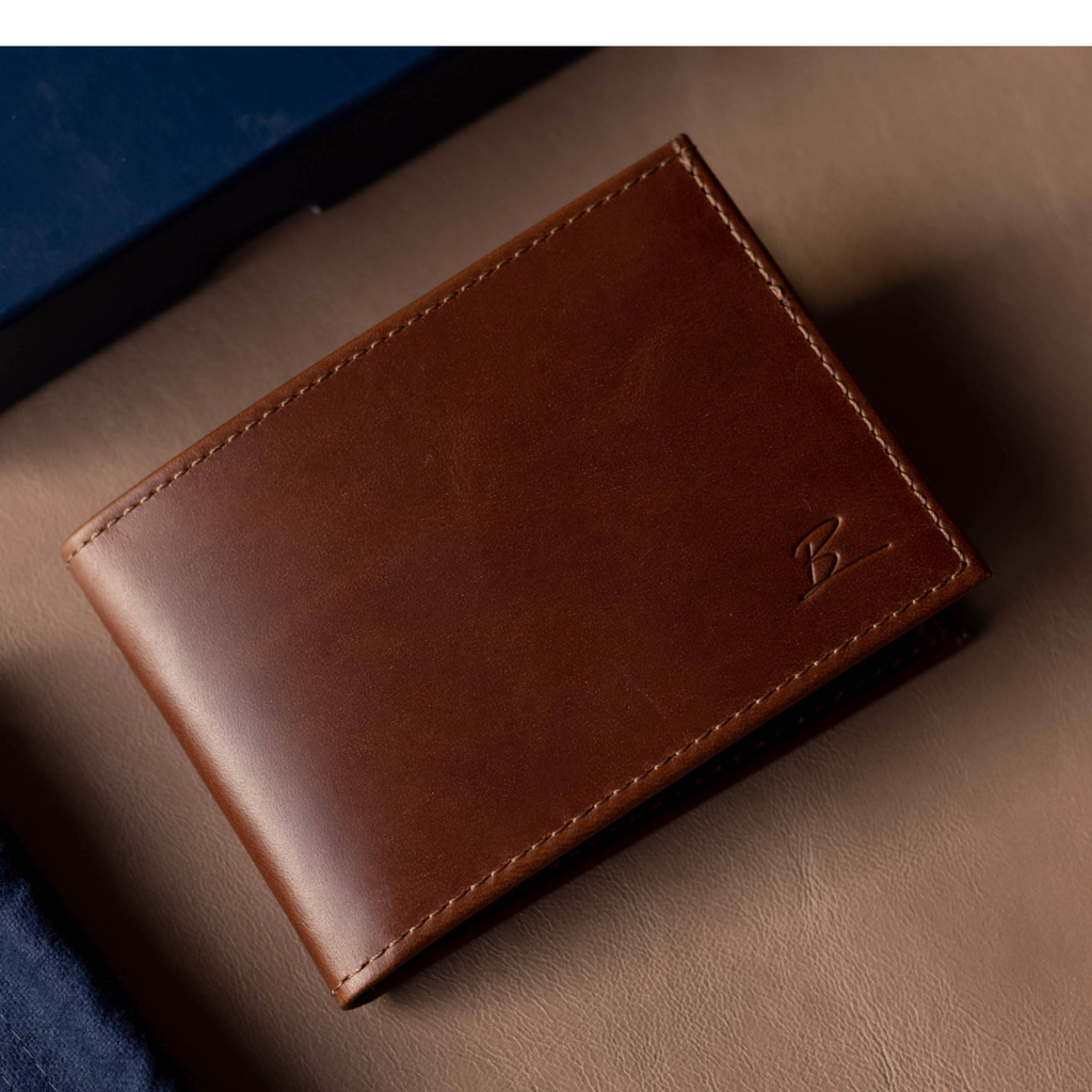 Brown leather bifold wallet with embossed logo