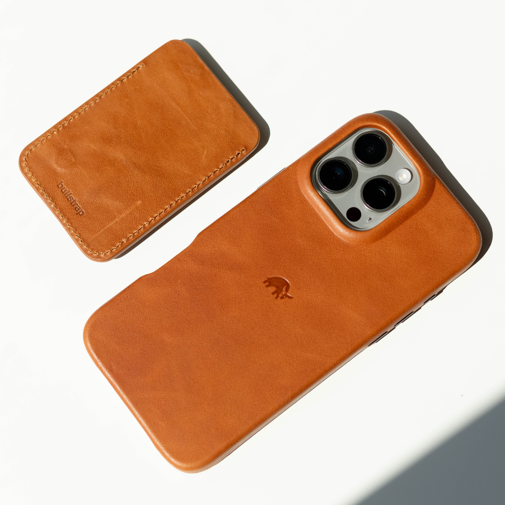Sienna leather phone case with matching NavSafe wallet stamped 'bullstrap' on white background