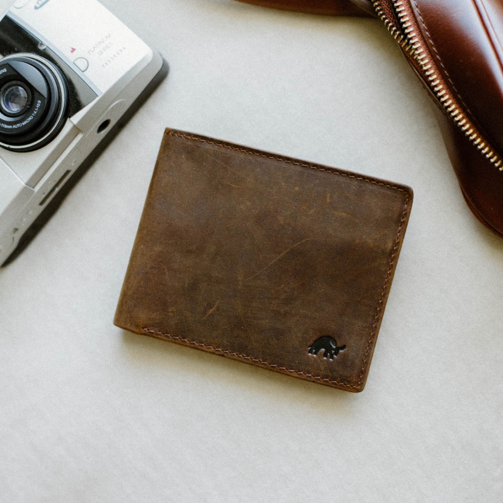 Distressed brown leather bifold wallet with embossed elephant logo
